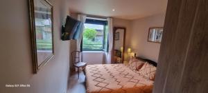a bedroom with a bed and a flat screen tv at Le Panoramic in Err +10 photos