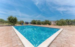 a swimming pool with blue water in a yard at Casa Mare Drage in Drage