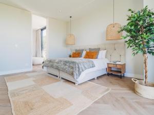 a bedroom with a bed and a potted tree at Fairbourne's View, Kingswood Golf Estate George in George