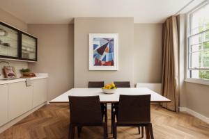 a kitchen and dining room with a table and chairs at Native Hyde Park in London
