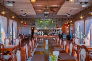 a long dining room with a long table and chairs at LCS Hotel & Apartment in Phnom Penh