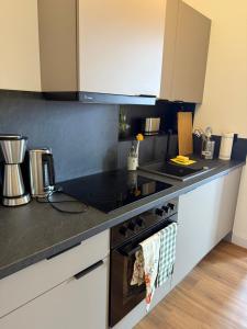 a kitchen with a stove and a counter top at 181 City View Hamburg in Hamburg +48 photos