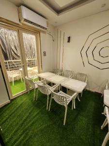 a dining room with a table and chairs and a window at LiLi HOTEL vip in Mansoura