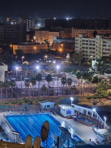 a large swimming pool at night in a city at LiLi HOTEL vip in Mansoura