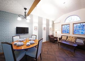 a dining room with a table and chairs and a couch at Shinjuku Sakaue House in Tokyo