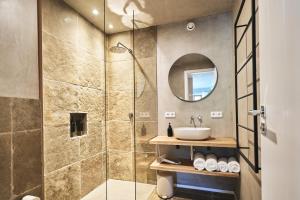 a bathroom with a shower and a sink at Das Flachshaus Boutique Apartments in Aidling +124 photos