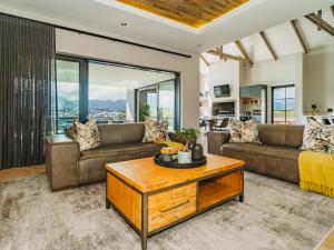 a living room with two couches and a coffee table at 40 Ridge Drive, Kingswood Golf Estate in George