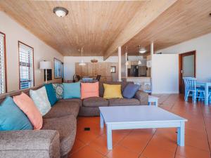a living room with a couch and a table at Beachfront property, Victoria Bay, Garden route in Victoria Bay