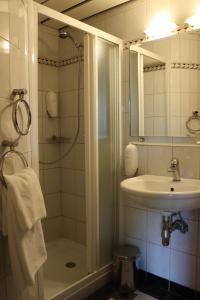 a bathroom with a shower and a sink at MC Hotel in Žalec