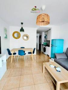 a living room with a table and a couch at Casa Gala in Corralejo