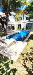 a swimming pool in front of a house at Villa golf de Montchoisy in Mont Choisy