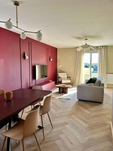 a living room with a table and a couch at Maison B - Mont Saint Michel in Marcey-les-Grèves +33 photos