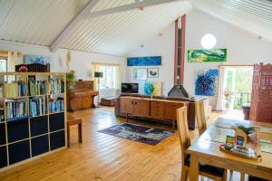a living room with a table and a fireplace at Y Beudy at Coed Melin Aberporth in Tremain