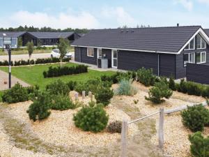a house with a garden in front of it at Luxury Retreat with Pool - By Traum Ferienwohnungen in Nørre Nebel