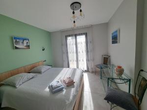 a bedroom with a bed with two folded towels on it at Havre de paix en Drôme villa moderne climatisée - jacuzzi "la maison d'à côté" in Chatuzange-le-Goubet