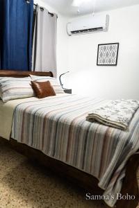 Ένα ή περισσότερα κρεβάτια σε δωμάτιο στο Cozy Home in San Juan, Puerto Rico - Perfect for Families