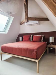 a bedroom with a bed with red sheets and a window at Number 9 holiday apartments in Middelburg +30 photos