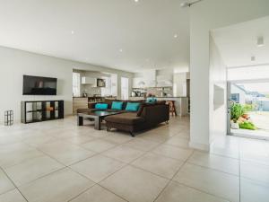a living room with a couch and a table at Knights Retreat on Kingswood Golf Estate in George