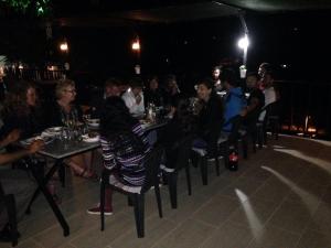 a group of people sitting at tables at a restaurant at night at Hotel Sema in Patara