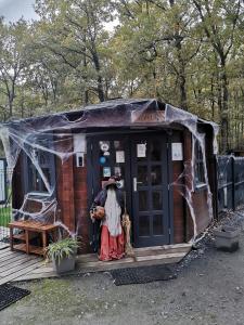 a person standing outside of a tiny house at La Parenthèse Meslandaise in Mesland