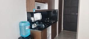 a kitchen with a counter with a water bottle in it at Nestora in Ongata Rongai 