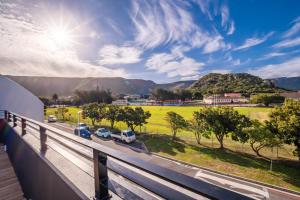 a view from a balcony of cars parked on a road at The Wild Oak in Hermanus