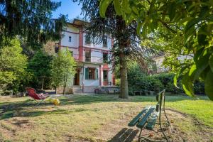 a house with a red chair in front of it at Villa Spa Dalia in Cannobio