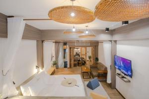 a living room with a couch and a table at Krung Boutique Hotel in Bangkok