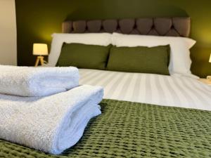 a bedroom with a bed with towels on the floor at Old Grey Mare in York