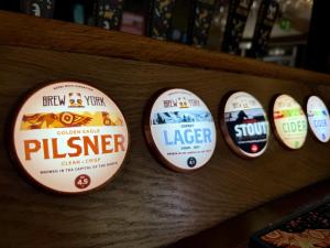 a bunch of signs on a shelf with labels at Old Grey Mare in York