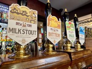 a bar with three bottles of wine on a counter at Old Grey Mare in York