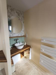 a bathroom with a sink and a mirror at Douce Parenthèse au bord de l'eau in La Celle-sous-Gouzon +52 photos