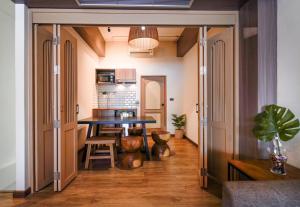 a kitchen with a table and a dining room at Krung Boutique Hotel in Bangkok +33 photos