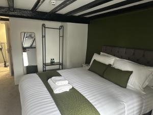 a bedroom with a bed with towels on it at Old Grey Mare in York