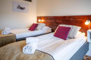 a room with two beds with towels on them at Hotel Arctic Zone in Ruka