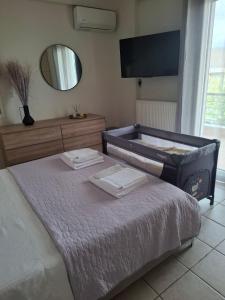 a bedroom with a bed with two towels on it at V & G House in Tripoli