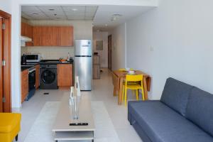 a living room and kitchen with a couch and a table at Khayali Marina Holiday Homes Dubai Marina JBR in Dubai