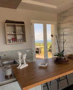 a kitchen with a wooden table with a view of the ocean at Loft Irene With Private Pool in Tergu
