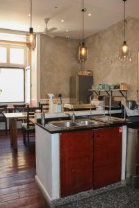 a large kitchen with a sink and a table at Rossio Hostel in Lisbon +126 photos