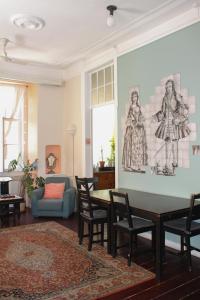 a living room with a table and chairs and a couch at Rossio Hostel in Lisbon