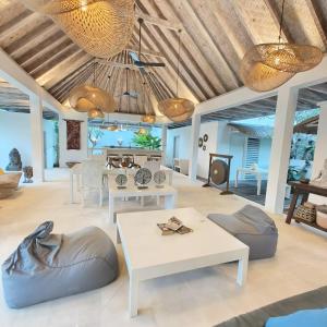 a living room with a table and chairs at OMAÏA Private villas in Amed
