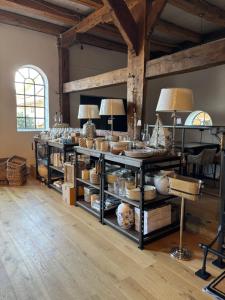 a room with shelves filled with dishes and lamps at Edelhof1877 in Thedinghausen