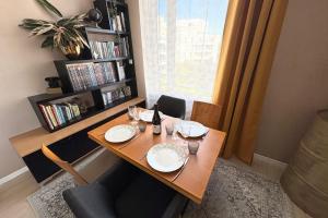 a dining room table with plates and wine glasses on it at Le Beauvoir a chic haven near Strasbourg in Strasbourg