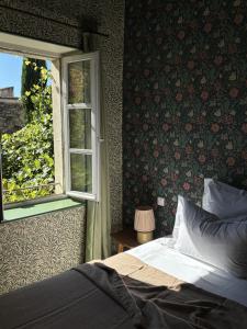 a bedroom with a bed and a window at Le Clos de Gordes in Gordes