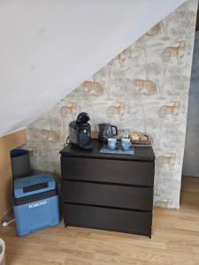 a room with a dresser and a staircase at Chambre d'Hôtes à Magny le Hongre in Magny-le-Hongre
