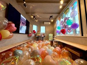 a bunch of balloons are lined up in a store at Tsubame Zushi Hayama in Zushi