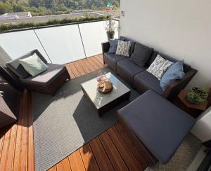 a living room with a couch and a table at Le Beauvoir a chic haven near Strasbourg in Strasbourg