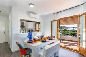 a kitchen with a table and chairs in a room at Villa Elisa in Nerja