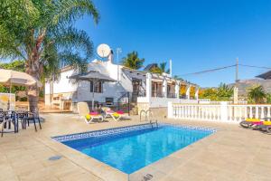 a house with a swimming pool in a yard at Villa Elisa in Nerja