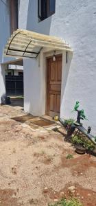 a door of a building with awning in front at Perivale Budget Stay in Moratuwa